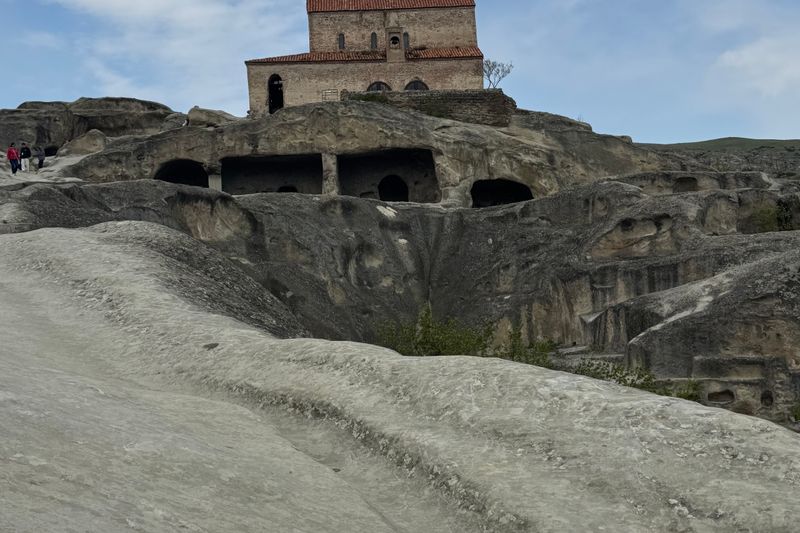 The rock-hewn cave town of Uplistsikhe with its ancient church carved into the Georgian plain